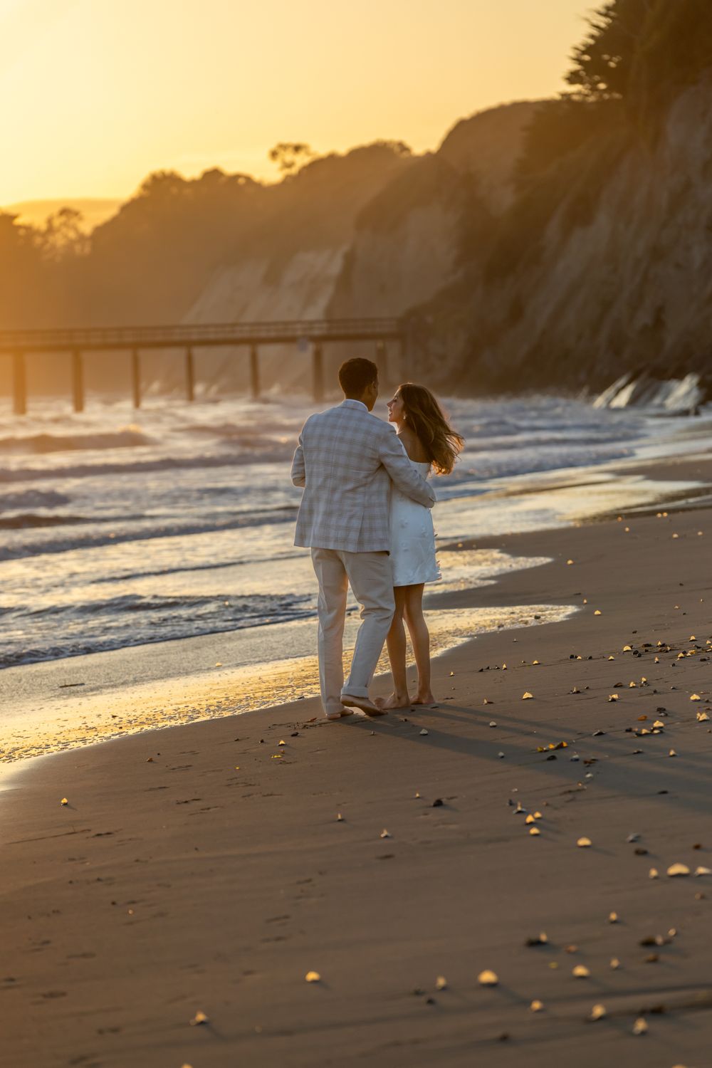 Ria and Sunder on the beach at sunset